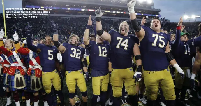  ?? AP FILE ?? DIFFERENT SCHEDULE: Members of the Notre Dame football team sing after a game against Virginia Tech in South Bend, Ind., on Nov. 2, 2019. .