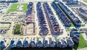  ??  ?? Costly land: Homes under constructi­on in Ontario, Canada. Toronto land prices have gotten so high that developers are struggling to build new homes that people can afford. — Bloomberg