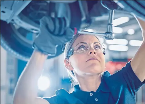  ??  ?? A mechanic repairs a car, as MOT and vehicle servicing are deemed essential work during the latest lockdown