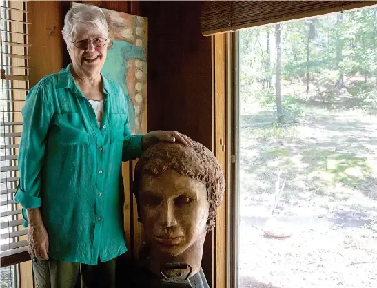  ?? Staff photo by Hunt Mercier ?? Nina Stingley Goldman poses for a portrait next to one of her clay sculptures July 12 in Texarkana, Ark. Goldman is a painter and sculptor who creates works of art from mixed mediums.