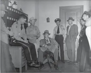  ??  ?? Above: Law enforcemen­t officers and other officials who participat­ed in the Phantom Killer investigat­ion gather in the Miller County Sheriff’s Office in June 1946. The group included Miller County Chief Deputy Tillman Johnson, Arkansas State Police...