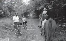  ?? Provided by Local Motion ?? Cyclists meet horseback riders on the Hop River State Park Trail in Connecticu­t.