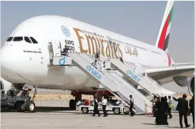  ??  ?? DUBAI: Visitors look at an Emirates airline’s Airbus A380 displayed at the Dubai Airshow yesterday. — AFP