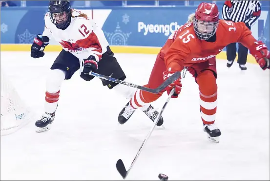  ??  ?? Canada’s Meaghan Mikkelson and Russia’s Valeria Pavlova (right), chase the puck in the women’s semifinal ice hockey match between Canada and the Olympic Athletes from Russia during
the Pyeongchan­g 2018 Winter Olympic Games at the Gangneung Hockey...