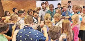  ??  ?? Youth delegates pray for Oklahoma United Methodist Bishop Jimmy Nunn during a youth luncheon on May 31 at the Oklahoma United Methodist Conference’s annual meeting at Oklahoma City University
[PHOTO PROVIDED BY HOLLY MCCRAY]