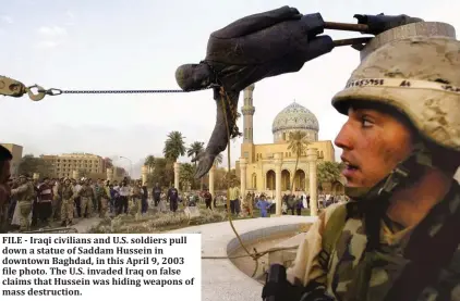  ??  ?? FILE - Iraqi civilians and U.S. soldiers pull down a statue of Saddam Hussein in downtown Baghdad, in this April 9, 2003 file photo. The U.S. invaded Iraq on false claims that Hussein was hiding weapons of mass destructio­n.