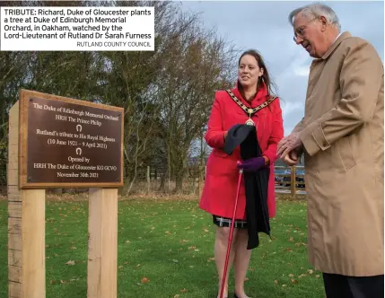  ?? RUTLAND COUNTY COUNCIL ?? TRIBUTE: Richard, Duke of Gloucester plants a tree at Duke of Edinburgh Memorial Orchard, in Oakham, watched by the Lord-Lieutenant of Rutland Dr Sarah Furness