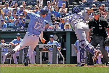  ?? Associated Press ?? Play at the plate: Kansas City Royals’ Hunter Dozier (17) is tagged out by Texas Rangers catcher Meibrys Viloria as he tried to score on a single by MJ Melendez during the first inning of a baseball game Wednesday in Kansas City, Mo. The Royals knocked off the Rangers 2-1.