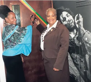  ?? PHOTOS BY MEL COOKE ?? Mitzie Williams (left), communicat­ion manager, Bob Marley Foundation and Margaret Little Wilson, the Alpha Institute’s administra­tor, cuts the ribbon, officially opening the Bob Marley Ensemble Room.