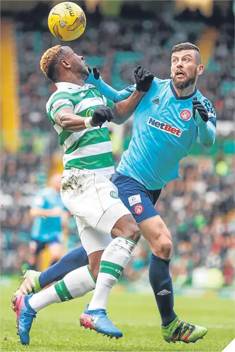  ??  ?? Moussa Dembele gets the better of former Celt Massimo Donati at Parkhead yesterday.