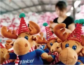  ??  ?? A woman works on toys to be exported to the U.S. at a toy factory in Lianyungan­g City, eastern China's Jiangsu Province. Xinhua