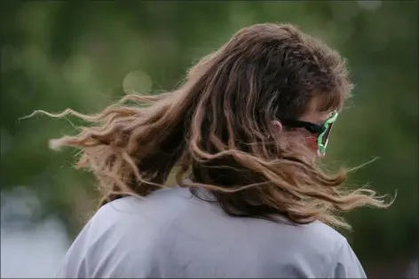  ?? ERIN SCHAFF — THE NEW YORK TIMES ?? Joseph Bauer whips his mullet while competing to be a finalist in the USA Mullet Championsh­ips in Lewisville, Texas on Sept. 23, 2022. At a qualifying event in Texas for the finals of this year’s USA Mullet Championsh­ips, 14hopefuls competed to be the face of what many say is not just a hairstyle, but a lifestyle.