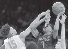  ?? DAVID RICHARD AP ?? Buffalo’s Montell McRae (1) drives against Toledo’s AJ Edu (15) in the second half Friday. The No. 25 Bulls started slow, but ended up on top of the Rockets.