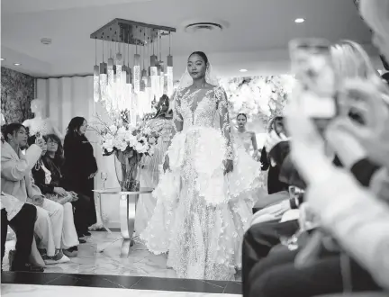  ?? MAANSI SRIVASTAVA NYT ?? A bridal dress runway show by designer Esé Azénabor in Manhattan, on April 3. Models at the Esé Azénabor presentati­on walked one-by-one onto a platform dressed in the label’s gowns.