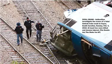  ??  ?? FATAL CRASH - Authoritie­s investigat­e the scene of a fatal Amtrak train crash in Cayce, South Carolina, Sunday, Feb. 4, 2018. At least two were killed and dozens injured. (Tim Dominick/The State via AP)