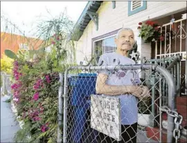 ??  ?? RAMIRO FLORES, 73, has lived in his home for 26 years in an industrial area of Boyle Heights that is the focus of a new city of Los Angeles developmen­t plan.