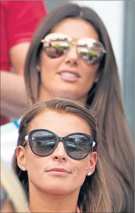  ??  ?? Coleen Rooney, front, at Euro 2016 football match between England and Wales, blames fellow footballer’s wife Rebekah Vardy for leaks