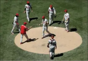  ?? GREGORY BULL — THE ASSOCIATED PRESS ?? Philadelph­ia Phillies starting pitcher Nick Pivetta, center, hands the ball to manager Pete Mackanin during the sixth inning of Wednesday’s game in San Diego.