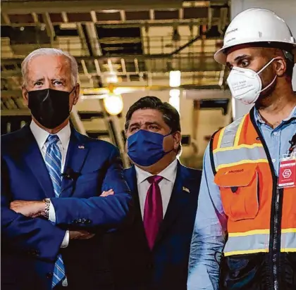  ?? Susan Walsh/Associated Press ?? President Joe Biden tours a Microsoft data center under constructi­on in Illinois with Gov. J.B. Pritzker, center, in 2021.