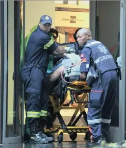  ?? PICTURE LEON LESTRADE ?? FINAL ACCOUNT: Paramedics remove one of the victims of last year’s shooting.