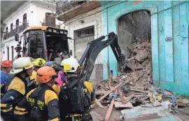  ?? RAMON ESPINOSA/AP, FILE ?? Firefighte­rs in Havana, Cuba clear debris from a building that partially collapsed, killing three people on Oct. 4. The Cuban government says the lack of material resources prevents it from tackling the problem of housing deteriorat­ion.