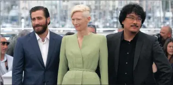  ?? PICTURES: AP ?? Actors Jake Gyllenhaal, Tilda Swinton and director Bong Joon-ho pose for photograph­ers during the photo call for the film Okja at the 70th internatio­nal film festival in Cannes, southern France, yesterday.