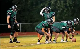  ??  ?? Oklahoma School for the Deaf quarterbac­k Dylan Evans signals to Tyler Manek in September against Kansas School for the Deaf.