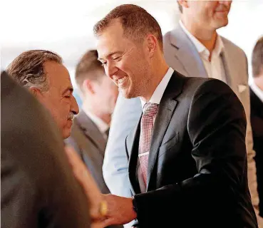  ?? [PHOTO BY STEVE SISNEY, THE OKLAHOMAN] ?? Lincoln Riley shakes hands with OU’s executive associate athletic director Larry Naifeh after Riley was introduced as the Sooners’ new head coach on June 7.