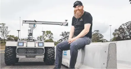  ?? Picture: Kevin Farmer ?? AGRICULTUR­AL ADVANCES: Toowoomba-raised Dr Stuart McCarthy demonstrat­es a motorised self driving robot to monitor feedlot feed trenches.