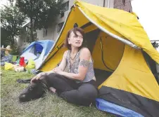  ??  ?? Shawna Mcfadden. 36, sits near a tent she put up on Wednesday on the property of the River Place apartments after her eviction.