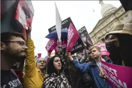  ?? MATTHEW DAE SMITH — LANSING STATE JOURNAL FILE ?? Abortion-rights advocates, right, try to block anti-abortion signage during a rally at the state capitol in Lansing, Mich.