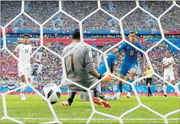  ?? BUDA MENDES/GETTY-AFP ?? Brazil’s Philippe Coutinho pushes a shot past Costa Rica goalkeeper Keylor Navas early in stoppage time Friday.