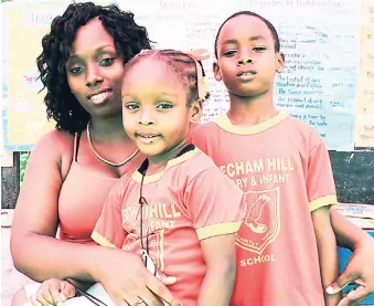  ?? ORANTES MOORE PHOTO ?? Vice-president of the parent-teacher associatio­n at Beecham Hill Primary and Infant School in Flint River, St Mary, Shamar Stona, with her children Najavalee and Tamarco (right).