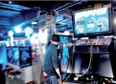  ??  ?? Yasushi Fukamachi, at the Mikado game centre, moving game machines after the centre closed early due to the state of emergency from the Covid-19 coronaviru­s in the Shinjuku district of Tokyo.
