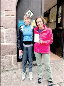  ?? Photo submitted ?? Every pilgrim on the Camino de Santiago must stop for a passport before beginning. Beth Haller and Carie O’Banion pose outside the Pilgrim office in St. Jean Pied de Port France.