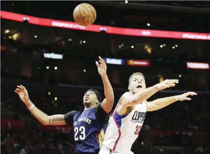  ??  ?? LOS ANGELES: Los Angeles Clippers’ Blake Griffin (right) and New Orleans Pelicans’ Anthony Davis watch the ball during the second half of an NBA basketball game on Friday, Nov 27, 2015. — AP