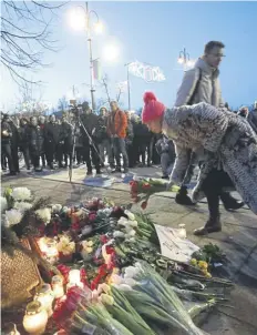  ?? PICTURE: PETRAS MALUKAS/AFP VIA GETTY IMAGES ?? A woman lays flowers at a makeshift memorial for Alexei Navalny in Vilnius, Lithuania yesterday