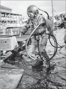  ?? Photograph: Historical Diving Society. ?? The fundraiser­s hope to make it to the top of Ben Nevis wearing one of these old diving suits.