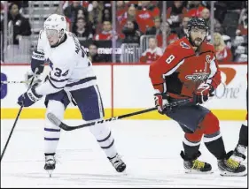  ?? Nick Wass The Associated Press ?? Toronto Maple Leafs center Auston Matthews (34) skates with the puck past Washington Capitals left wing Alex Ovechkin (8) on Saturday in Washington.