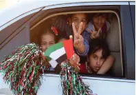  ??  ?? Children express their joy as they ride through the streets of Abu Dhabi on Saturday.