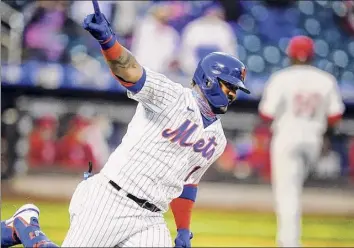  ?? Frank Franklin II / Associated Press ?? New York Mets' Jonathan Villar celebrates after hitting a single to drive in the winning run during extra innings of the first game of a doublehead­er against the Philadelph­ia Phillies.
