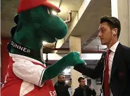  ??  ?? HANDS ON: Ozil with mascot Gunnersaur­us