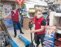  ?? BRIAN CASSELLA/CHICAGO TRIBUNE ?? Michael Trzupek, 21, left, and Logan Riedel, 22, work Wednesday at Gordon’s Ace Hardware in Chicago’s Oriole Park neighborho­od.