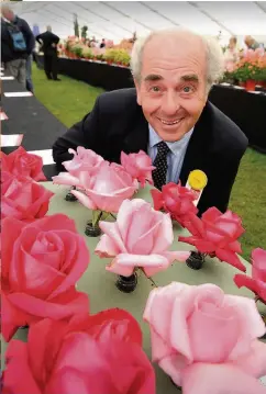  ??  ?? Smell the roses Judge Laurence Marcantoni­o with the roses exhibit which won the Fred Alderson Trophy 050816flow­er_ 02
