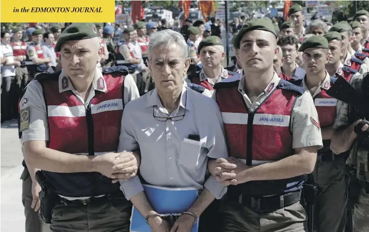  ?? BURHAN OZBILICI / THE ASSOCIATED PRESS ?? Paramilita­ry police and special force members escort Akin Ozturk, a former Turkish air force commander accused of terrorism and treason, outside a courthouse in Ankara. Ozturk is one of nearly 500 suspects, including a number of generals and military pilots, standing trial on charges of leading last year’s failed coup.