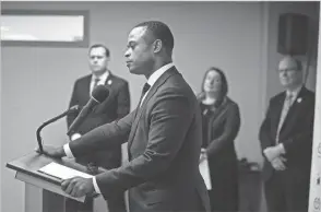  ?? MATT STONE/COURIER JOURNAL ?? Russell Coleman, who was elected as Kentucky’s attorney general, listens to outgoing Attorney General Daniel Cameron at a news conference last year. It’s time for Coleman to retire Cameron’s favorite catch phrase and instead of saying he “backs the blue,” simply say he’ll enforce the law.