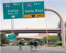  ?? ADOLPHE PIERRE-LOUIS/JOURNAL ?? Albuquerqu­e Police Traffic Unit officers investigat­e a fatal pedestrian accident on northbound Coors NW, near Iliff, on Thursday. The incident was one of two fatal crashes that took place that morning.