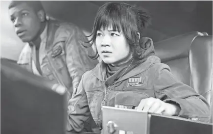  ??  ?? Rose Tico (Kelly Marie Tran) teams with Finn (John Boyega) for a mission in “Star Wars: The Last Jedi.” JONATHAN OLLEY