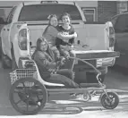  ?? BETHANY FREUDENTHA­L/LAS CRUCES SUN-NEWS ?? Grace Holguin, 14, is pictured on her trike, with her sisters Eve, 9, and Sophia, 10. The special trike was recovered after going missing.