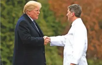 ?? AFP ?? ■ US President Donald Trump shakes hands with White House physician Rear Admiral Dr Ronny Jackson, who replaced Veterans Affairs Secretary David Shulkin yesterday.